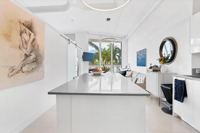a large white kitchen with a large window