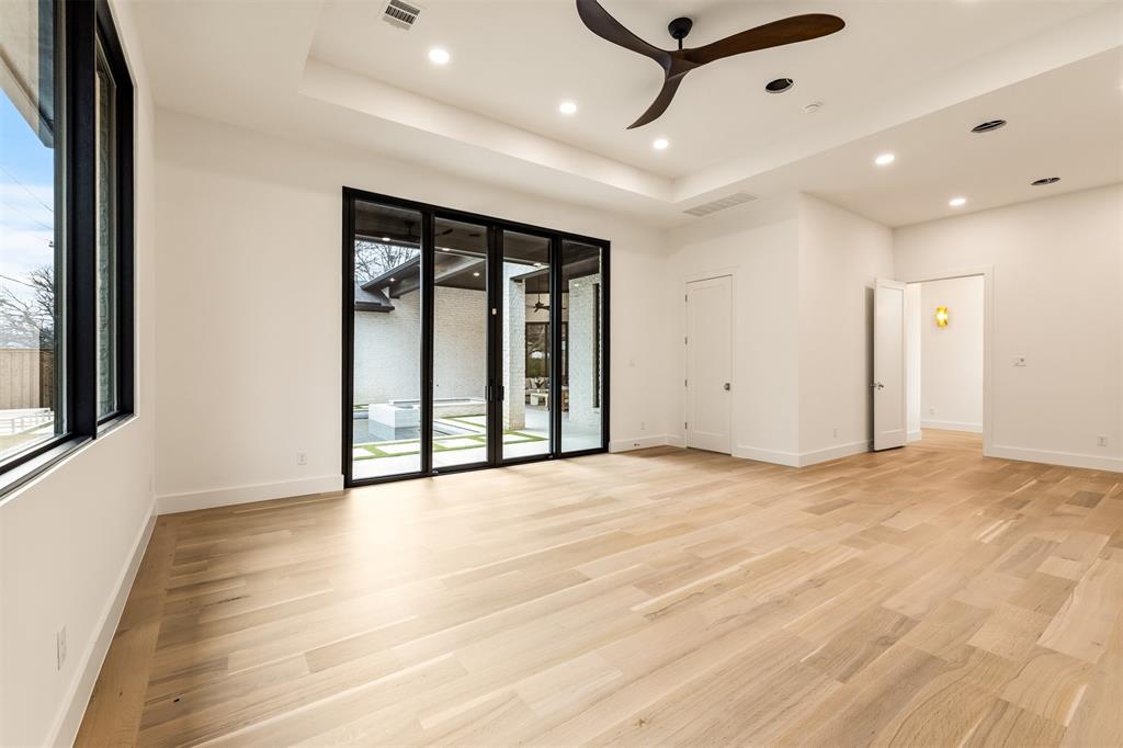 6123 Northaven Road Dallas, TX 75230 - Photo 18 of 40 Generous in size and thoughtfully placed, the main floor bedroom/game room offers flexible space for media, games, or casual seating