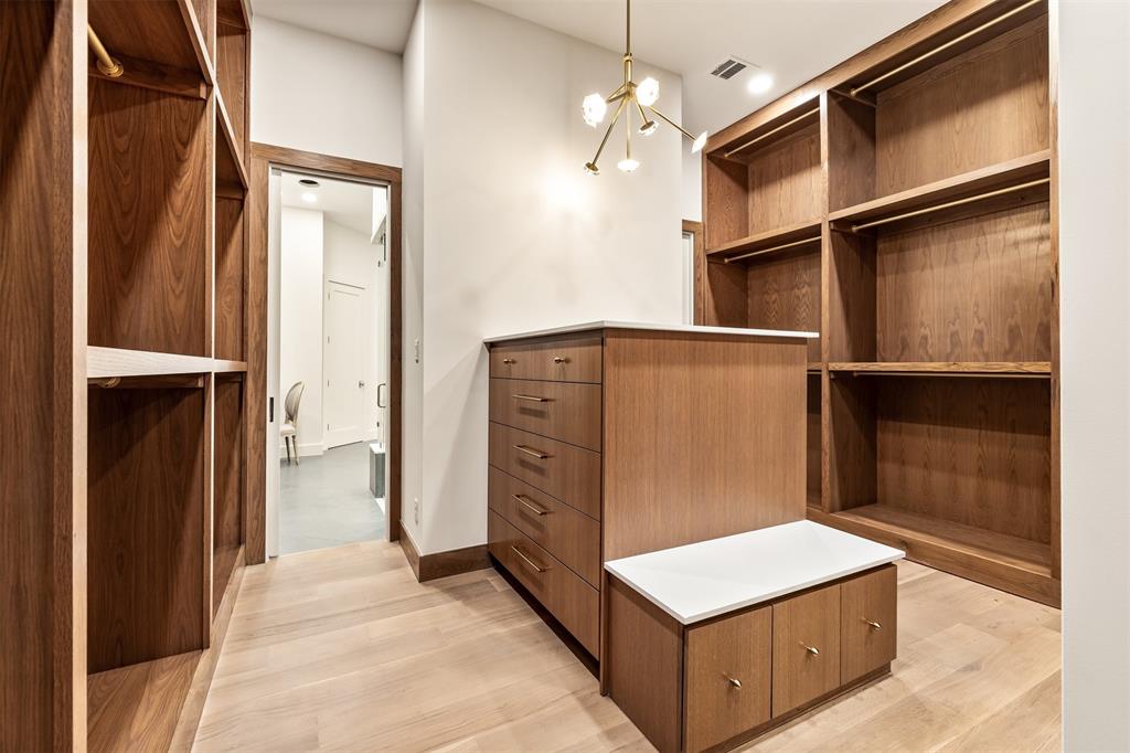 6123 Northaven Road Dallas, TX 75230 - Photo 26 of 40 Generous hanging space and shelving make the closet feel as polished and well planned as the rest of the home