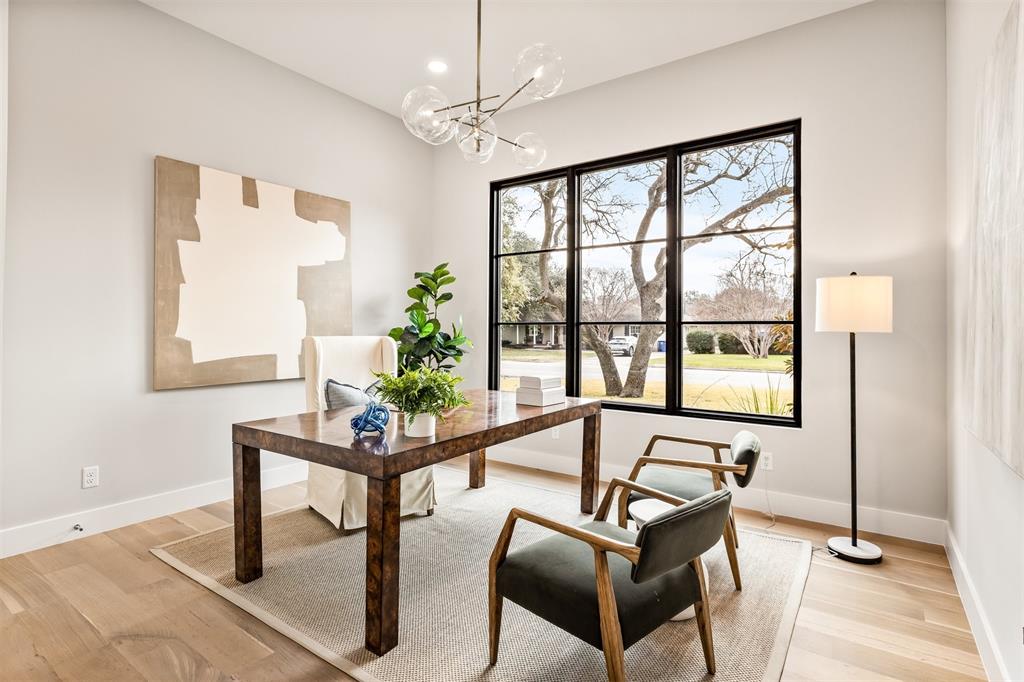 6123 Northaven Road Dallas, TX 75230 - Photo 5 of 40 A dedicated office positioned at the front of the home, offering a quiet, polished space for focused work or meetings, separate from the main living areas while still feeling connected to the flow of the house