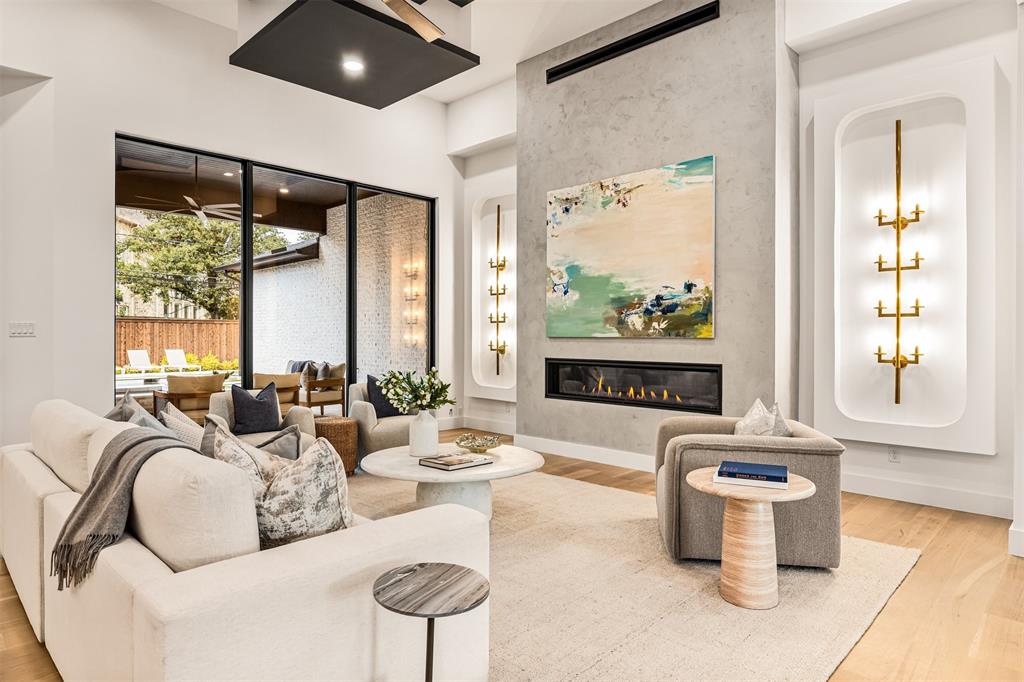 6123 Northaven Road Dallas, TX 75230 - Photo 7 of 40 Walls of windows line the living room, bringing in natural light and keeping the space visually connected to the backyard and pool area