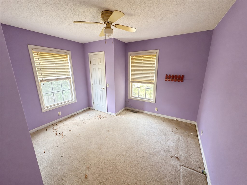 138 Cloverdale Road Seneca, SC 29678 - Photo 16 of 27 A quiet bedroom with sun-filled windows and ceiling fan, ready for personal touches.