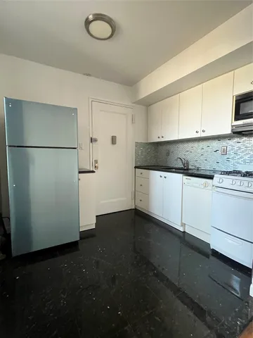 a kitchen with a refrigerator and a sink