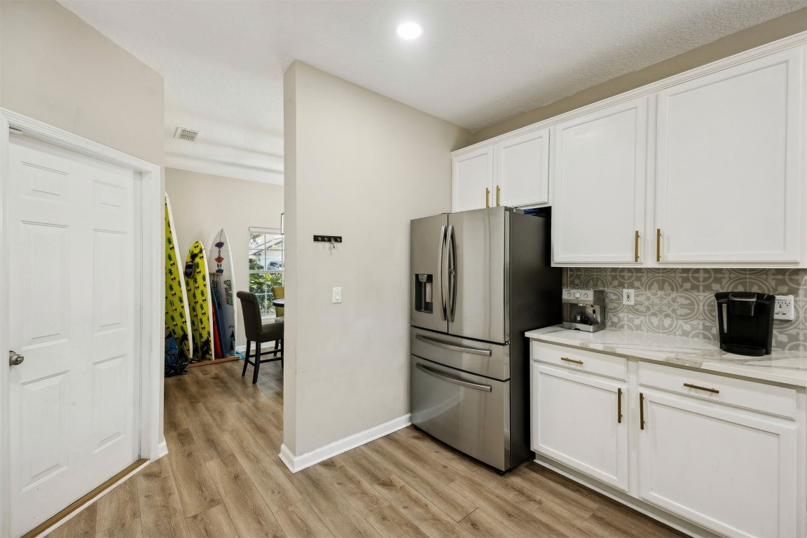 86126 Remsenburg Drive Fernandina Beach, FL 32034 - Photo 11 of 54 a kitchen with a refrigerator and a stove top oven