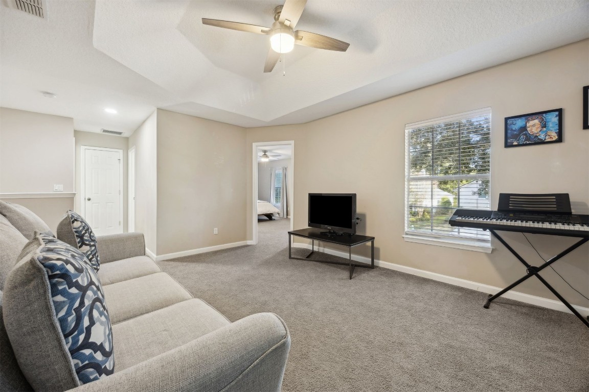 86126 Remsenburg Drive Fernandina Beach, FL 32034 - Photo 18 of 54 a living room with furniture and a flat screen tv