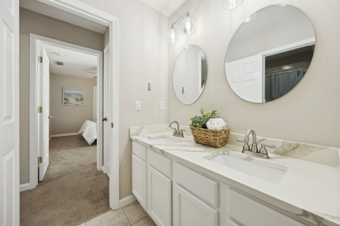 86126 Remsenburg Drive Fernandina Beach, FL 32034 - Photo 23 of 54 a en suite bathroom with a double vanity sink and a mirror