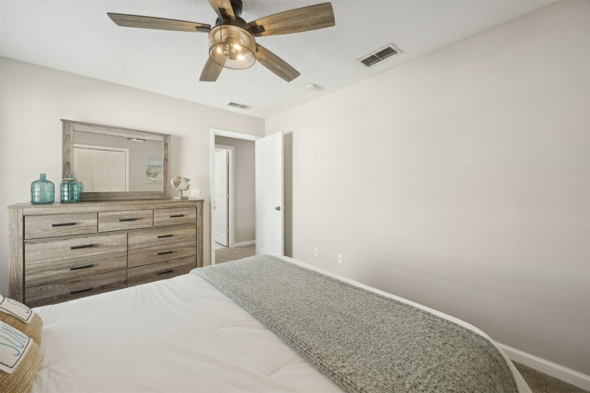 86126 Remsenburg Drive Fernandina Beach, FL 32034 - Photo 25 of 54 a bedroom with a bed and a dresser