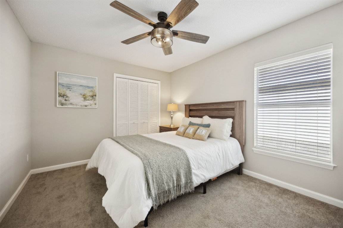 86126 Remsenburg Drive Fernandina Beach, FL 32034 - Photo 26 of 54 a bedroom with a bed and a ceiling fan