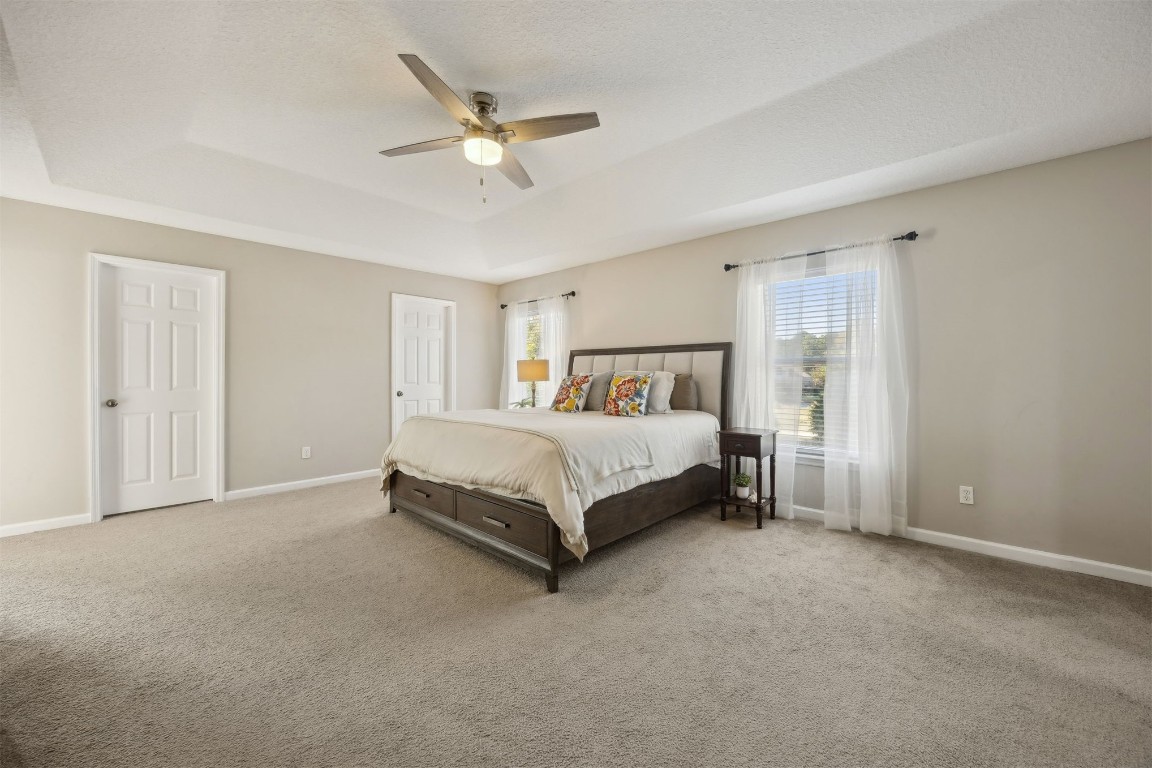 86126 Remsenburg Drive Fernandina Beach, FL 32034 - Photo 27 of 54 a bed sitting in a bedroom and a chandelier