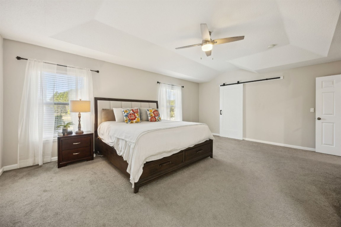 86126 Remsenburg Drive Fernandina Beach, FL 32034 - Photo 28 of 54 a bedroom with a large bed and a ceiling fan