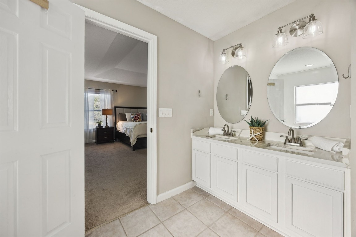 86126 Remsenburg Drive Fernandina Beach, FL 32034 - Photo 29 of 54 a en suite bathroom with double vanity sinks and a mirror