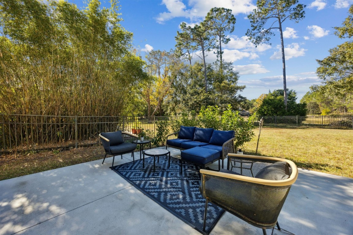86126 Remsenburg Drive Fernandina Beach, FL 32034 - Photo 35 of 54 a swimming pool with outdoor seating and plants