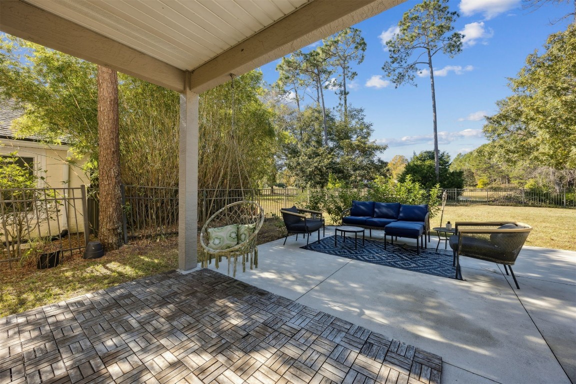 86126 Remsenburg Drive Fernandina Beach, FL 32034 - Photo 37 of 54 a view of a patio with a table chairs and a potted plant