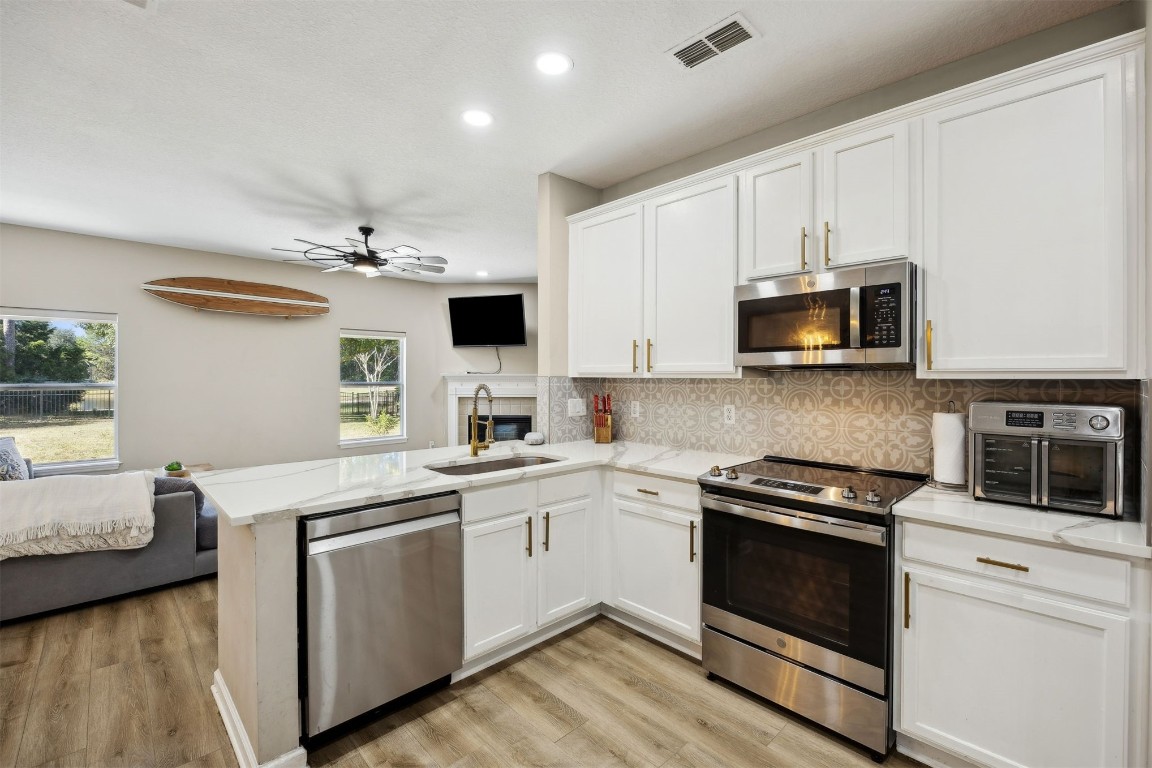 86126 Remsenburg Drive Fernandina Beach, FL 32034 - Photo 4 of 54 a kitchen with a sink stove and microwave