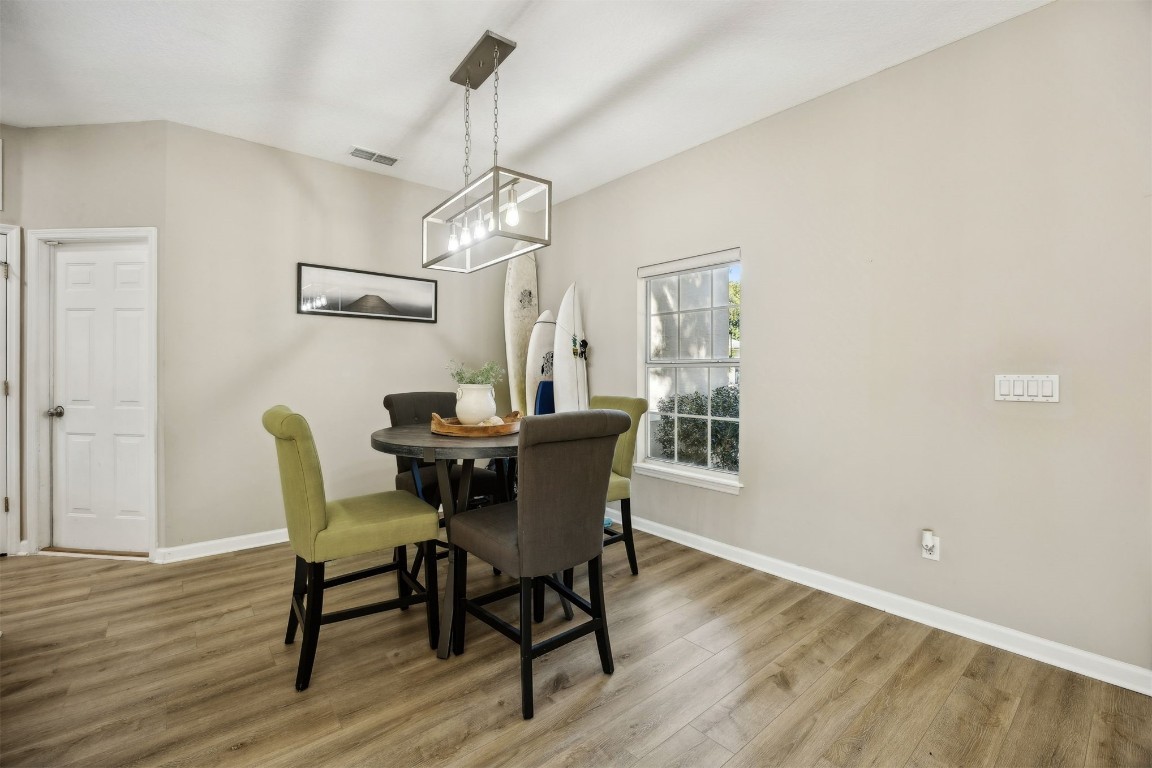 86126 Remsenburg Drive Fernandina Beach, FL 32034 - Photo 5 of 54 a dining room with furniture a chandelier and wooden floor