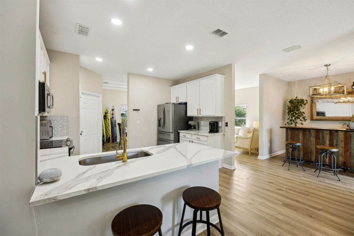 86126 Remsenburg Drive Fernandina Beach, FL 32034 - Photo 9 of 54 a kitchen with stainless steel appliances kitchen island granite countertop a sink and cabinets