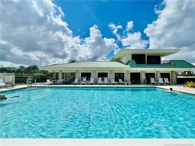 a view of balcony with wooden floor and trees in the background