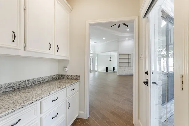 a bathroom with a granite countertop double vanity sink a mirror and a shower