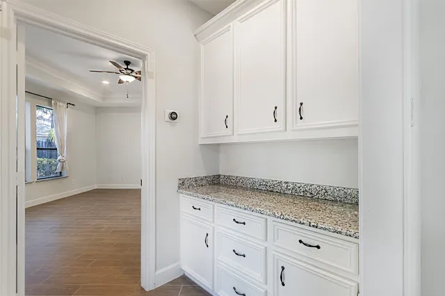 a spacious bathroom with a sink and a mirror