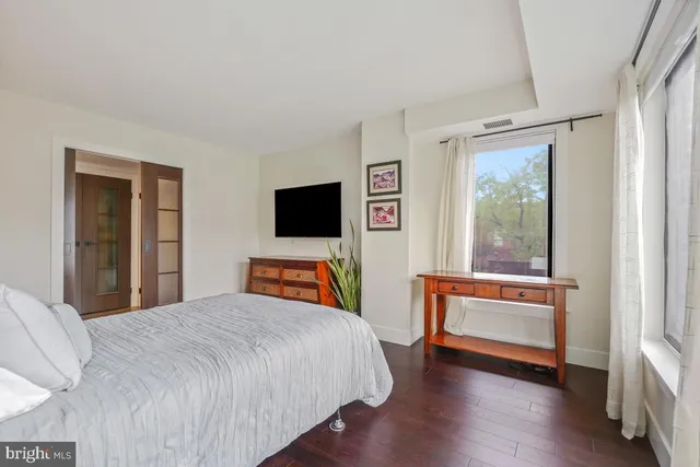 a bedroom with a bed and a flat screen tv