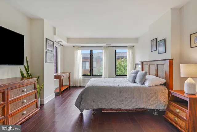 a bedroom with a bed and a large window