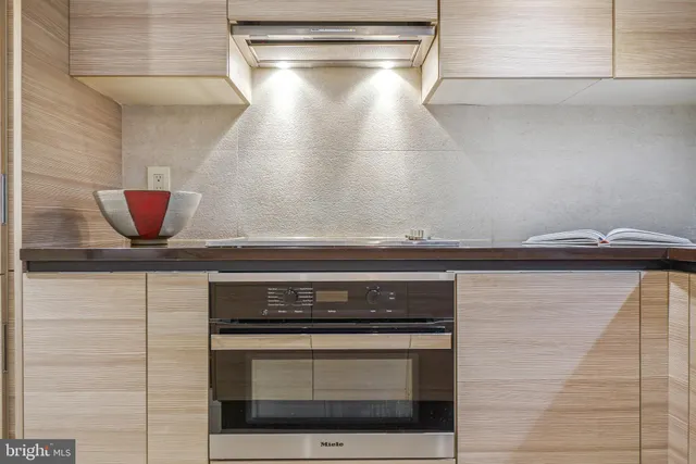 a stove top oven sitting inside of a kitchen