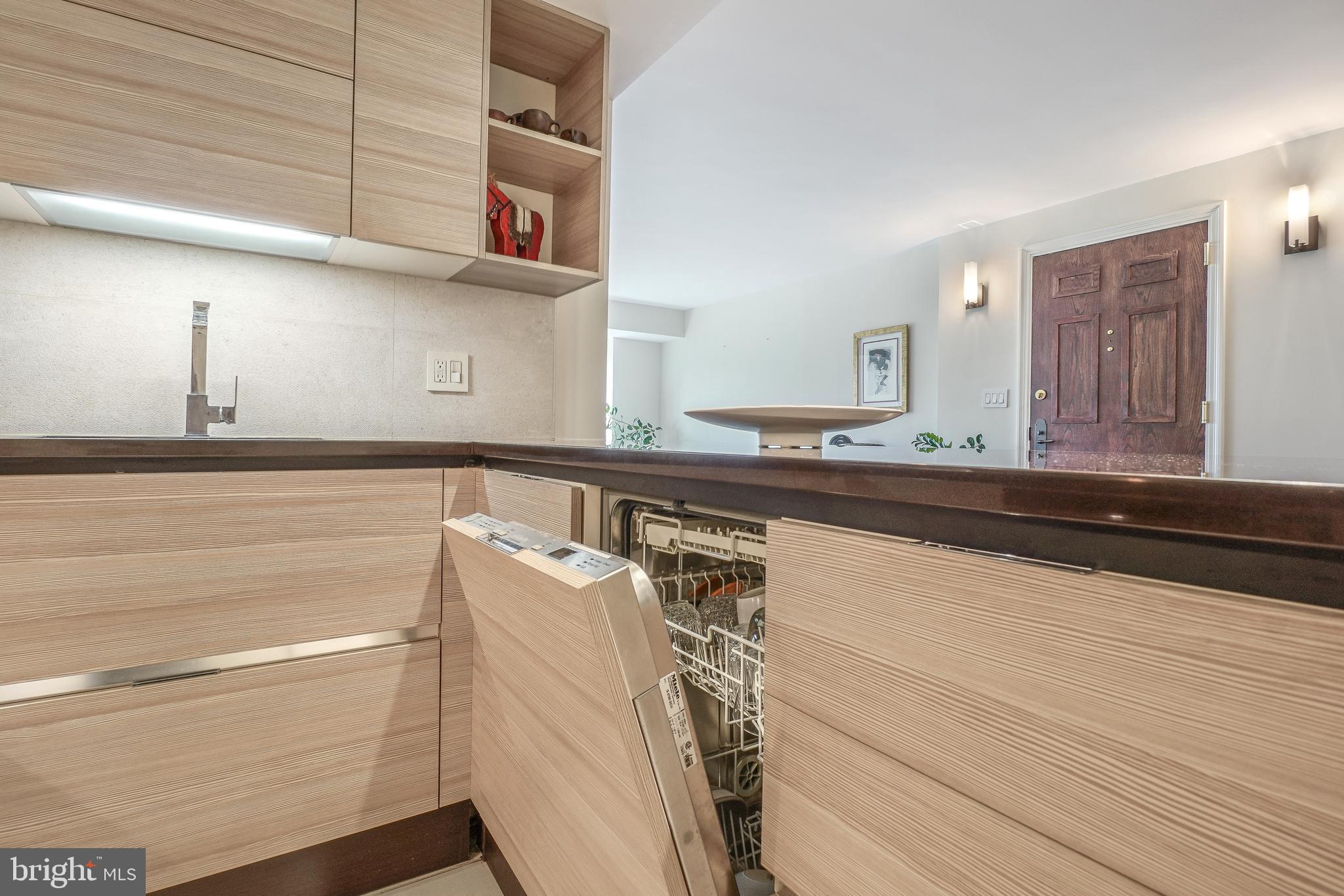 1080 Wisconsin Avenue Northwest, Unit 3002 Washington, DC 20007 - Photo 4 of 38 a kitchen with a sink and a refrigerator