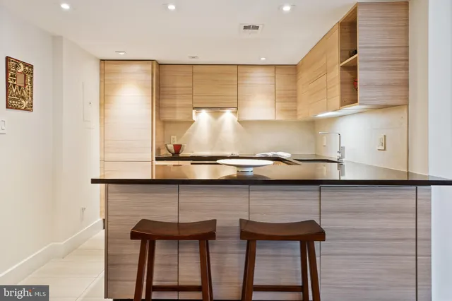 a kitchen with a table chairs in it and wooden floors
