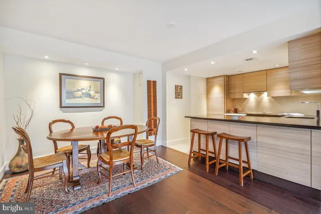 a view of a a dining room with furniture window and wooden floor
