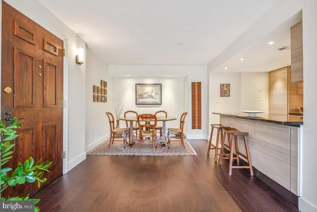 a view of a a dining room with furniture window and wooden floor