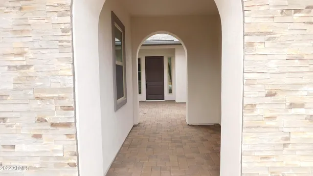 a view of a hallway with brick walls