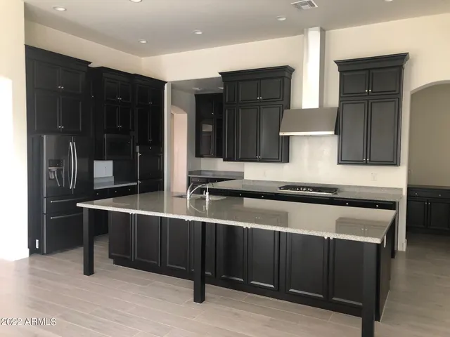 a kitchen with stainless steel appliances granite countertop a stove and a refrigerator