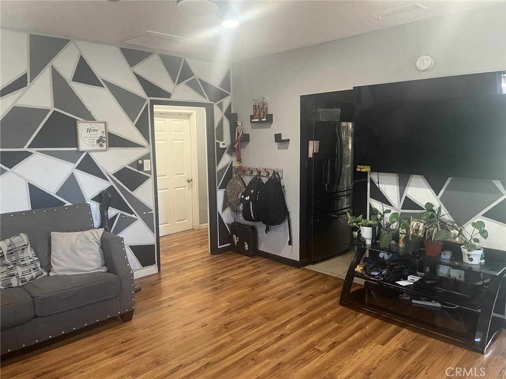 4264 Victoria Avenue Riverside, CA 92507 - Photo 4 of 11 a living room with furniture and a wooden floor