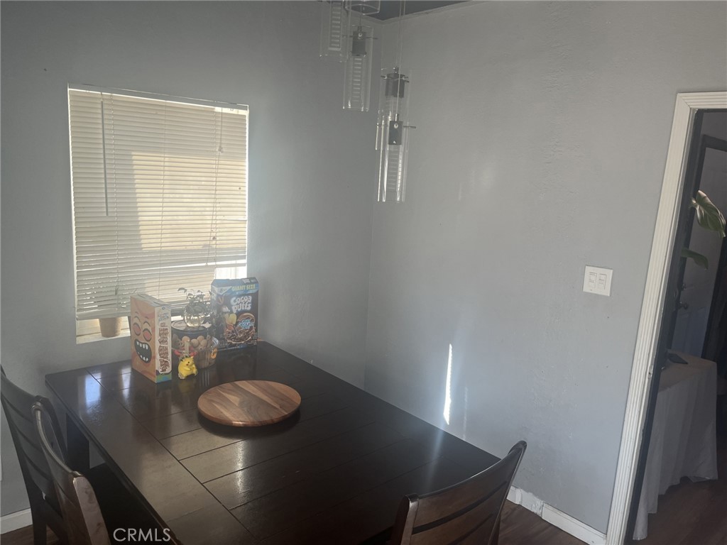 4264 Victoria Avenue Riverside, CA 92507 - Photo 7 of 11 a dining room with furniture and wooden floor