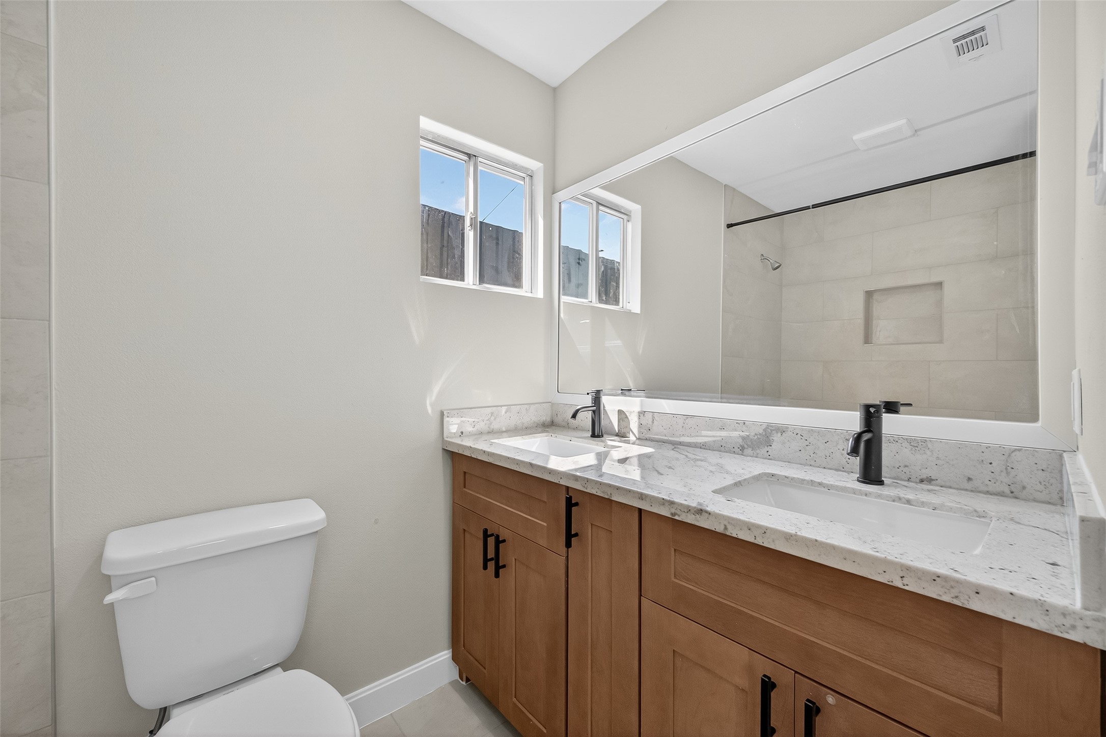 889 Chas Lane Houston, TX 77091 - Photo 26 of 32 a bathroom with a toilet sink and mirror