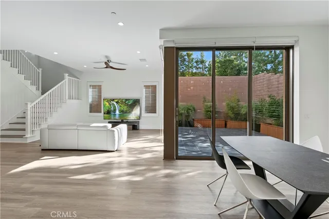 a view of a dining room with furniture wooden floor and windows