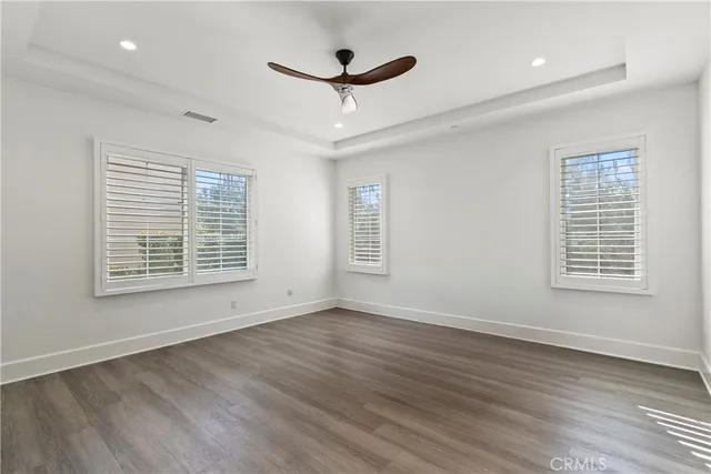 a view of a livingroom with a ceiling fan and wooden floor