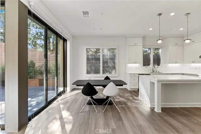 a living room with furniture a large window and white appliances