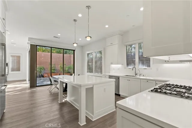 a large kitchen with a table and chairs