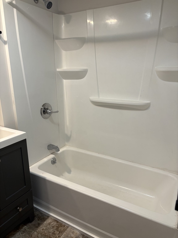 7 Morrill Street, Unit 7 Nashua, NH 03064 - Photo 13 of 15 a white bath tub sitting next to a shower