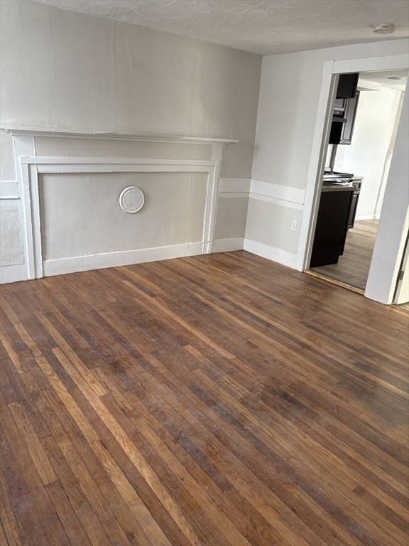 7 Morrill Street, Unit 7 Nashua, NH 03064 - Photo 2 of 15 a view of empty room with wooden floor