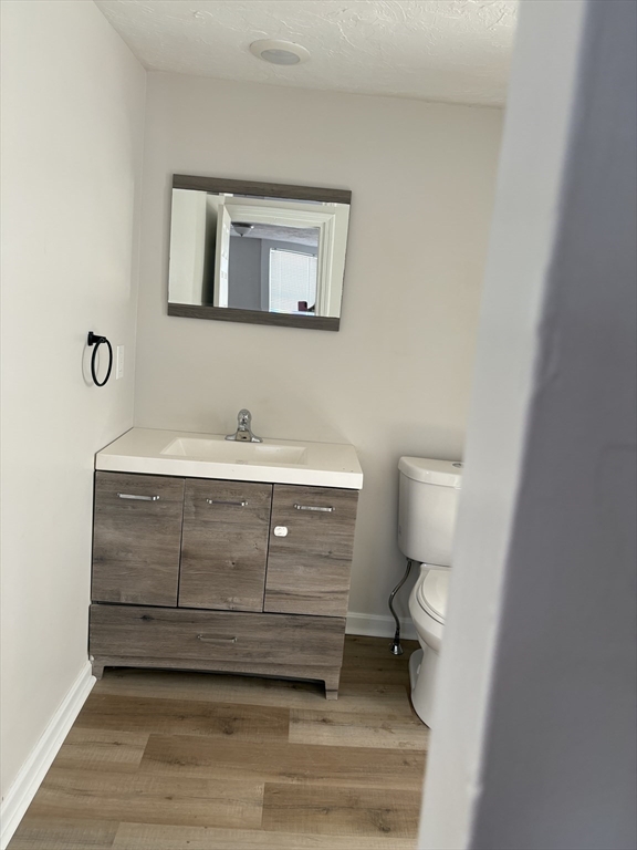 7 Morrill Street, Unit 7 Nashua, NH 03064 - Photo 7 of 15 a bathroom with a sink toilet and mirror
