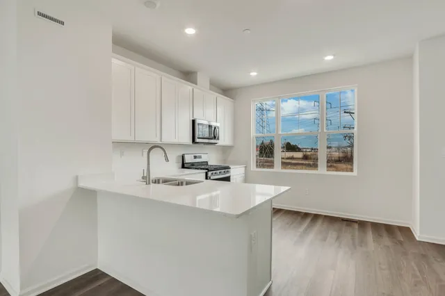 a kitchen with a sink a window and cabinets