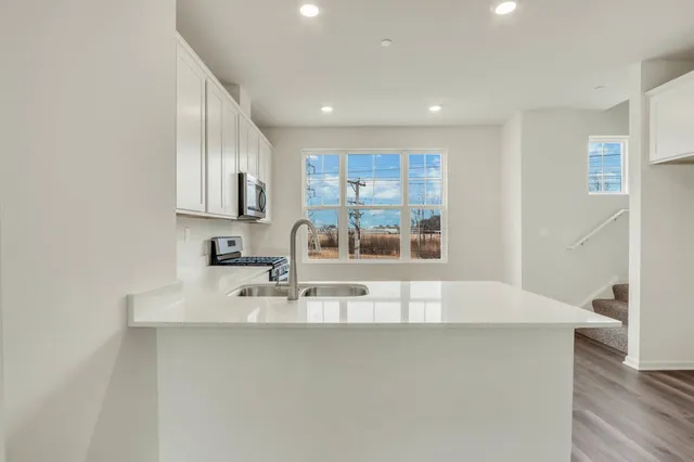 a view of kitchen with center island and stainless steel appliances