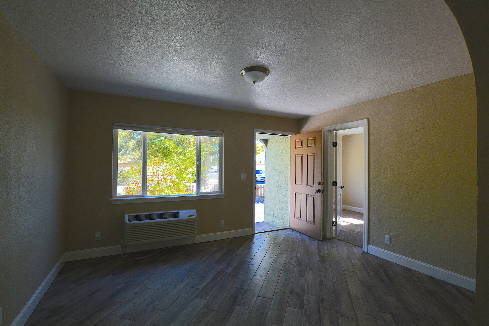 2230 El Reno Lane Redding, CA 96001 - Photo 13 of 27 an empty room with wooden floor and windows