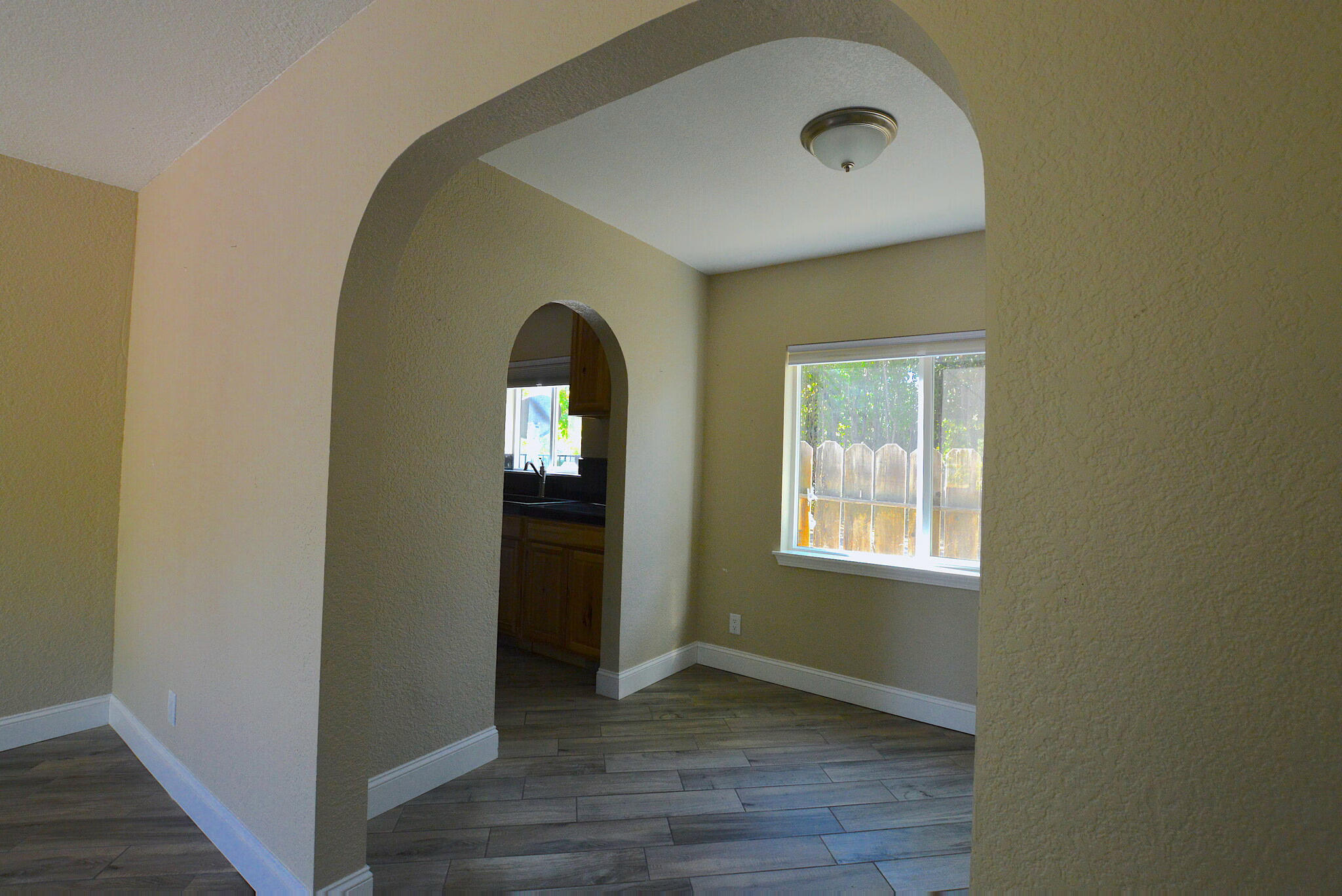2230 El Reno Lane Redding, CA 96001 - Photo 14 of 27 a view of an empty room with wooden floor and a window