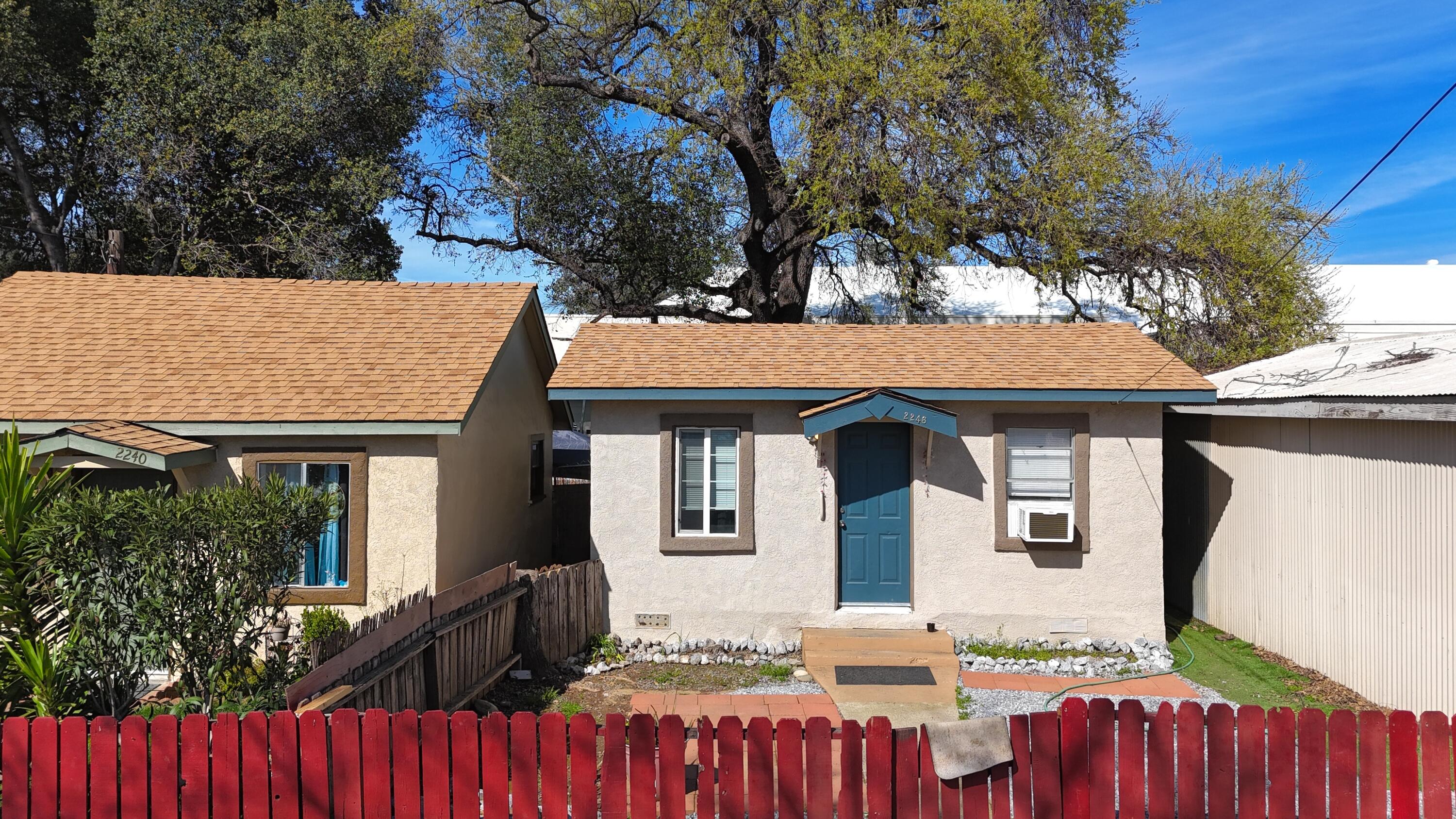 2230 El Reno Lane Redding, CA 96001 - Photo 7 of 27 a front view of house with yard outdoor seating and trees in the background
