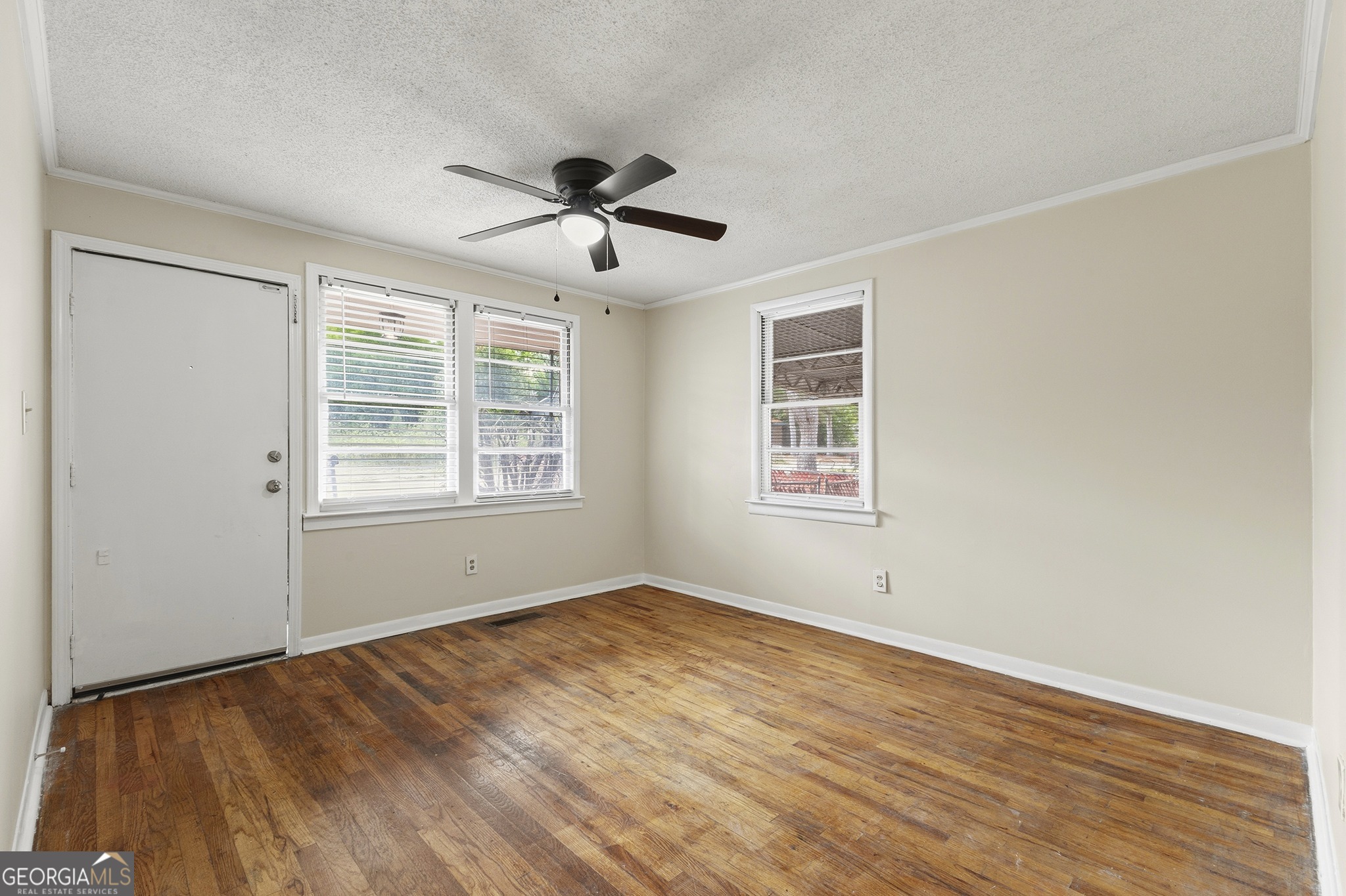 701 Grayson Avenue Macon, GA 31204 - Photo 7 of 17 a view of empty room with wooden floor and fan