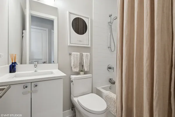 a bathroom with a toilet a sink and a mirror