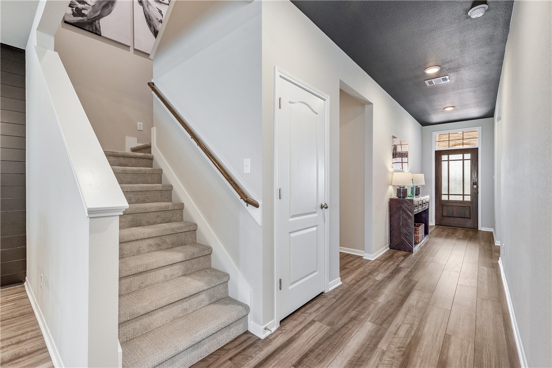 6309 Raleigh Drive College Station, TX 77845 - Photo 11 of 18 a view of a hallway with wooden floor and staircase